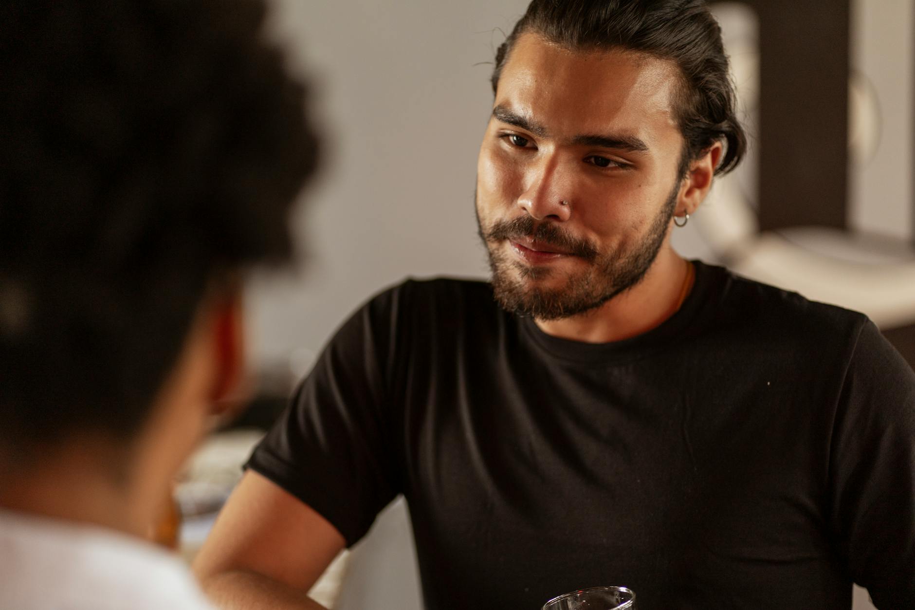 A man attentively engaged in a one-on-one conversation, illustrating the social communication differences that can appear in both ADHD and autism