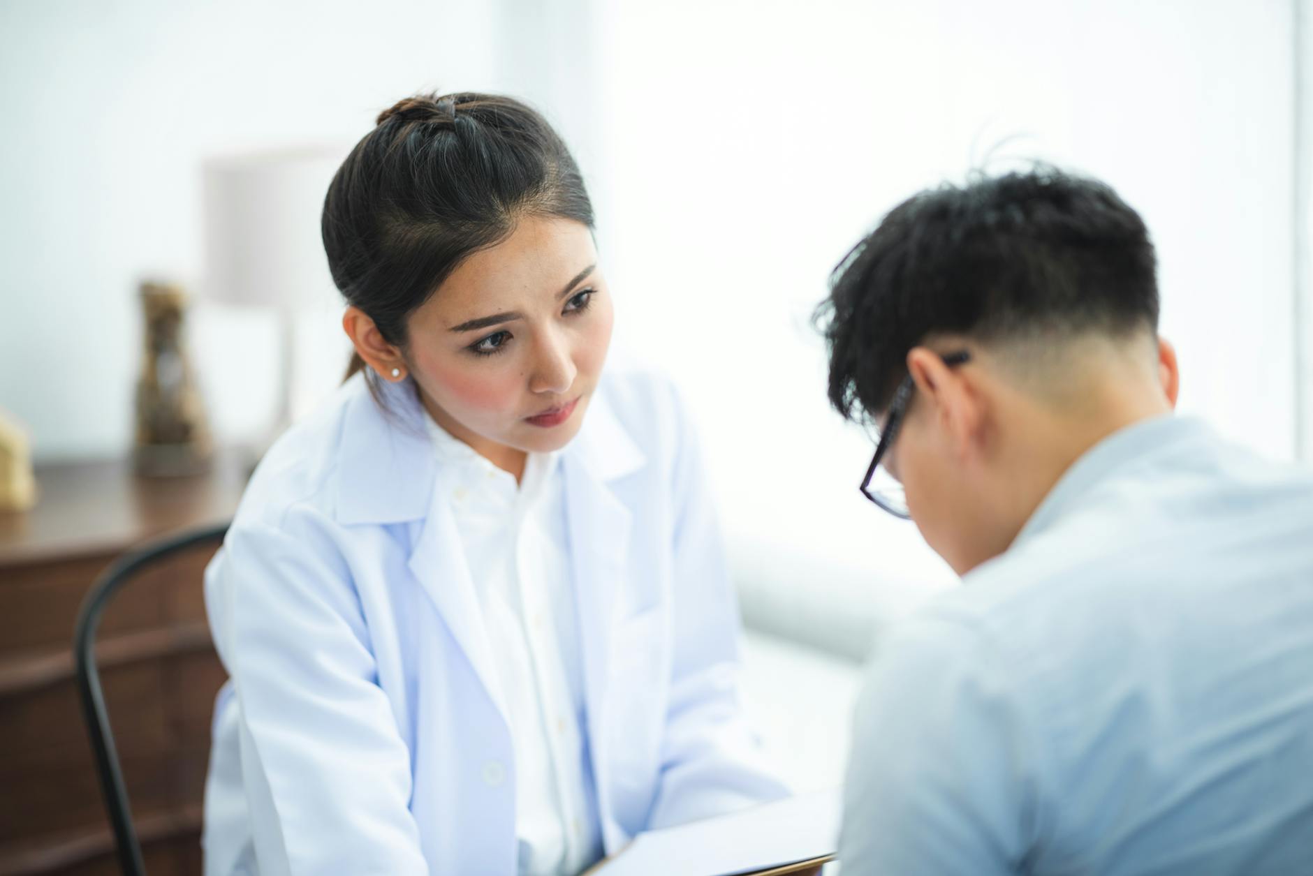 A doctor attentively listening to a patient during a medical consultation, illustrating the collaborative process of finding the right ADHD treatment